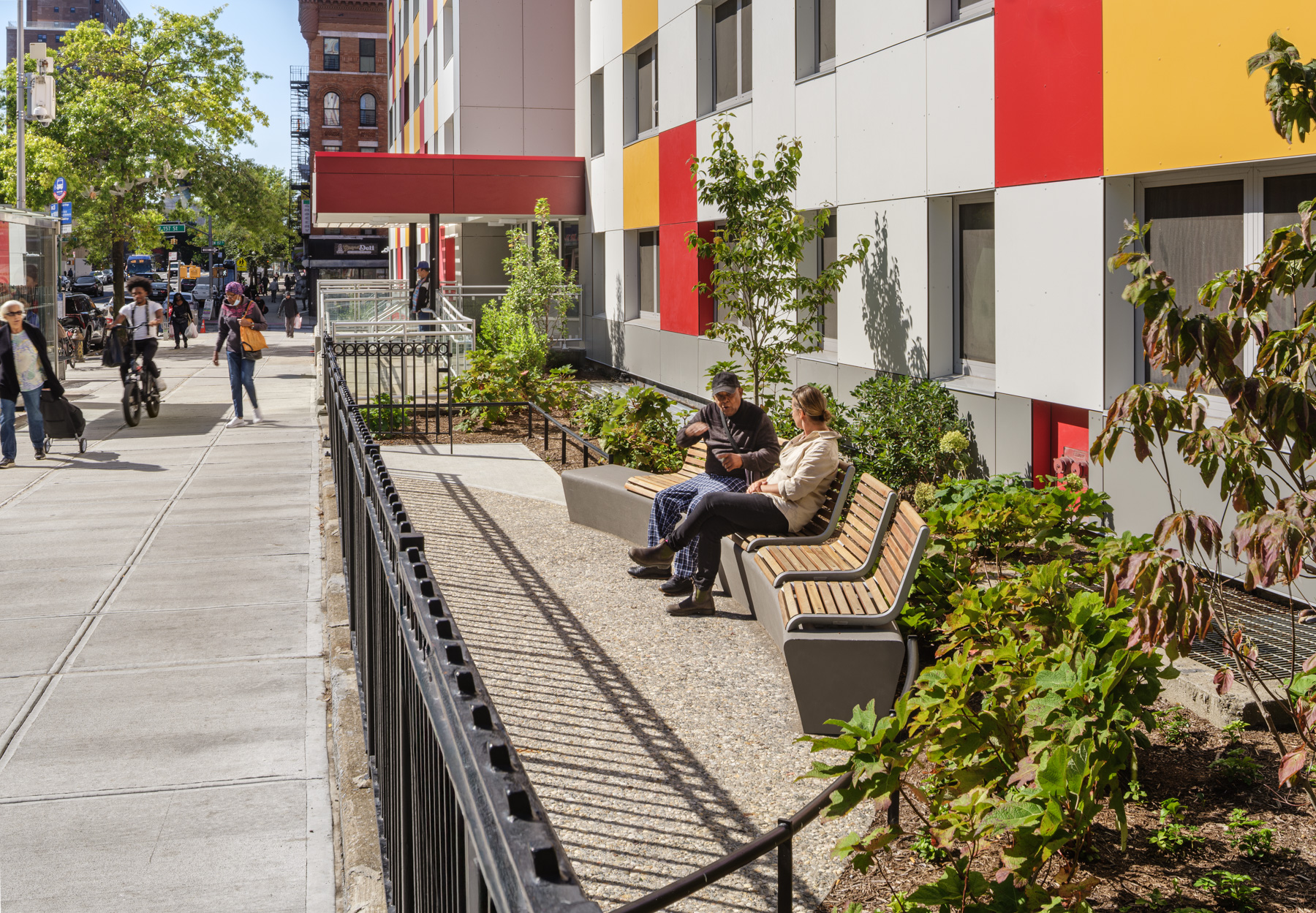 NYCHA PACT Marshall Plaza Street Seating and Planting Design – Washington Heights NYC Residents sitting along planted seating area at NYCHA PACT Marshall Plaza landscape renovation in Washington Heights, Manhattan designed by Joanna Pertz Landscape Architecture.