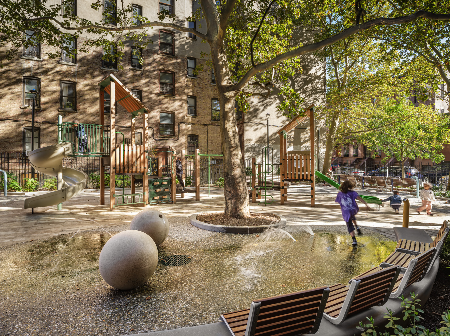 Splash play water feature and playground at NYCHA PACT Audubon Houses landscape renovation supporting outdoor play and community gathering in Washington Heights Manhattan